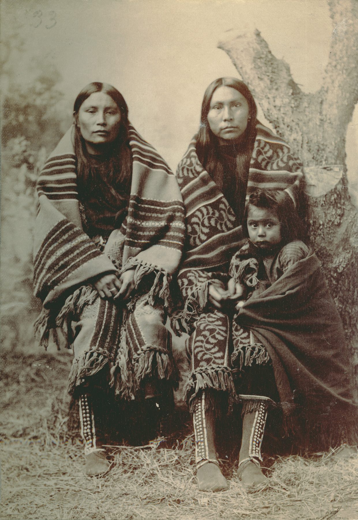 Historical portrait of two Comanche women and a child